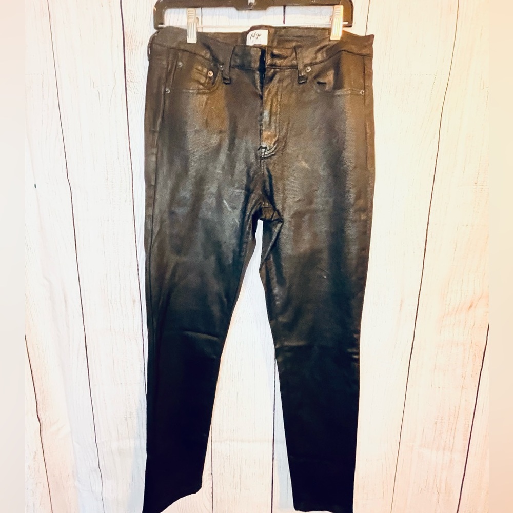 Black denim, type jeans with an embossed snake, like material.